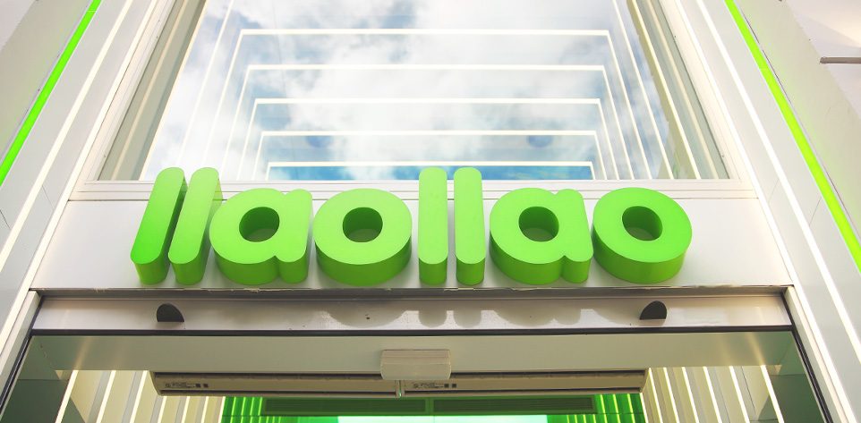 Fachada de una tienda llaollao con su letrero verde